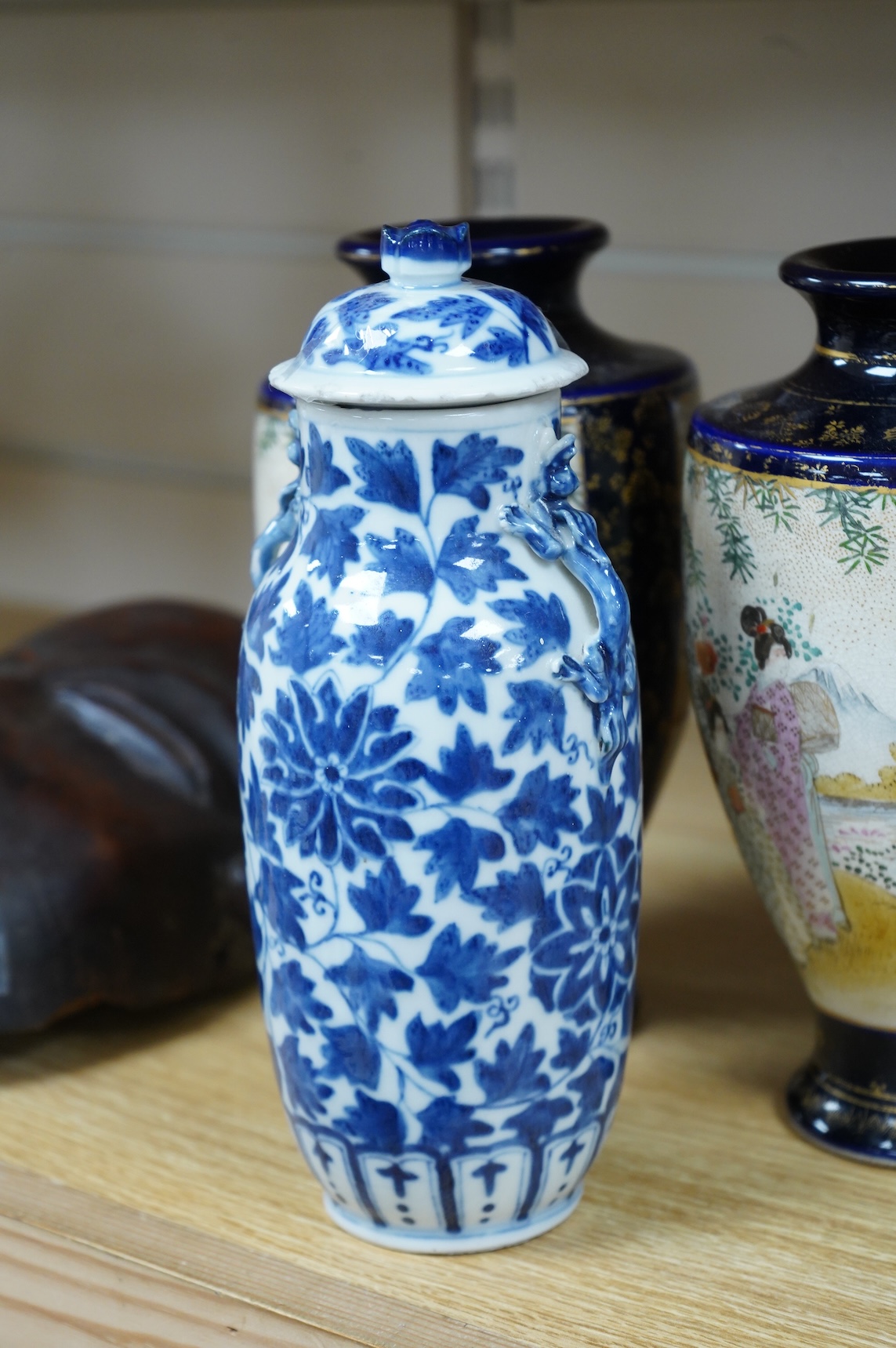 A late 19th century Chinese blue and white vase and cover and two Japanese Satsuma pottery vases, largest 24cm high